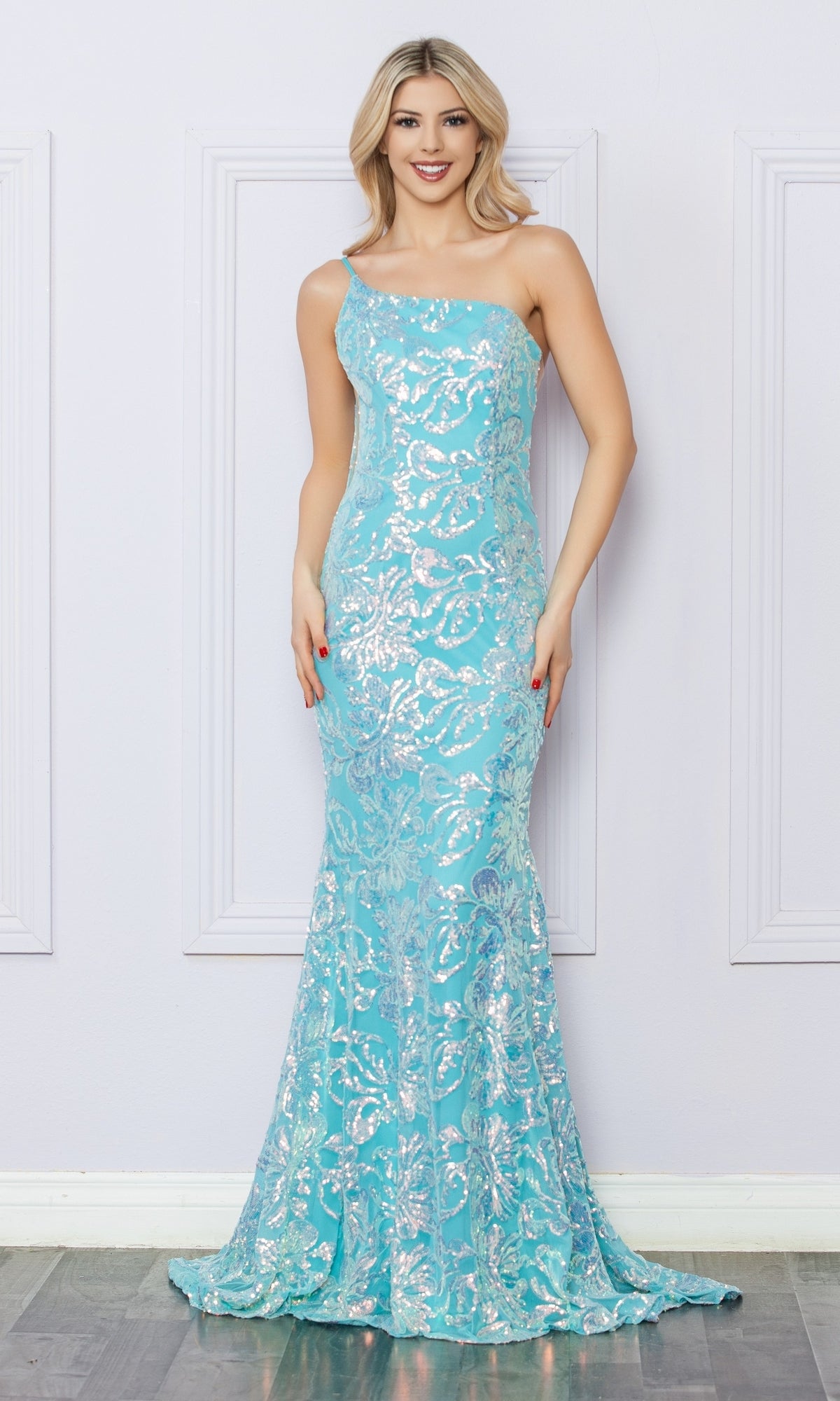 A woman models the One-Shoulder Long Sequin-Print Prom Dress R1308 in light blue, featuring silver sequin patterns, while standing against a light-colored wall.